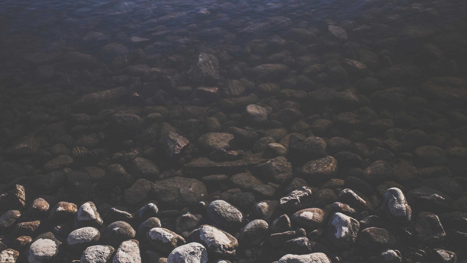 Overhead view of a table setting with layered glassware and candlelight